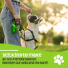 Person holding a dog on a leash with a green product, set against a blurred outdoor background.